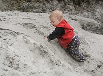 Tom digging in a sand bank