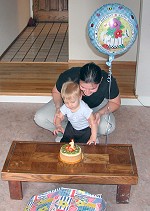 Tom is ready to reach into his first birthday cake