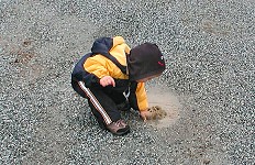 Descendant is splashing in a puddle