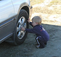 Tom patting wheels of our wagon